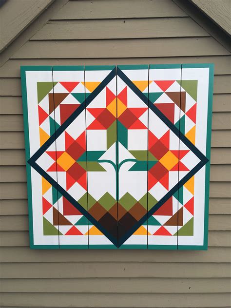 barn quilts for a tan and green metal house|barn quilts for sale.